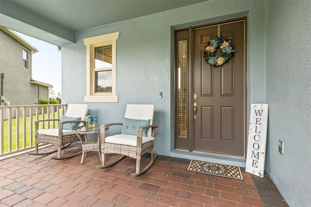 9844 Beach Port Dr, Winter Garden, FL 34787 - doorway to property featuring stucco siding and covered porch