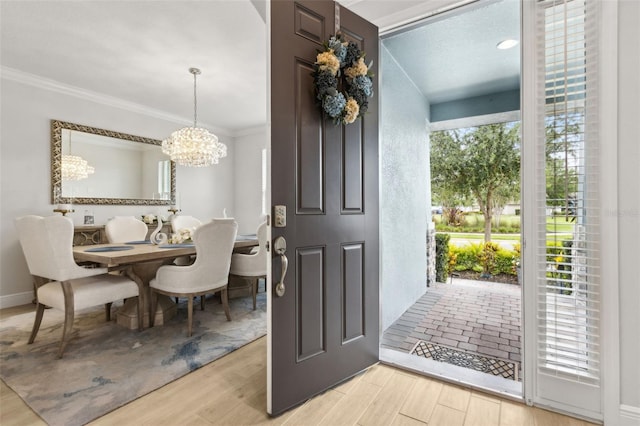 9844 Beach Port Dr, Winter Garden, FL 34787 - foyer featuring a chandelier, ornamental molding, and wood finished floors