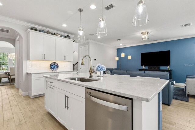 9844 Beach Port Dr, Winter Garden, FL 34787 - kitchen with dishwasher, a sink, open floor plan, arched walkways, and crown molding