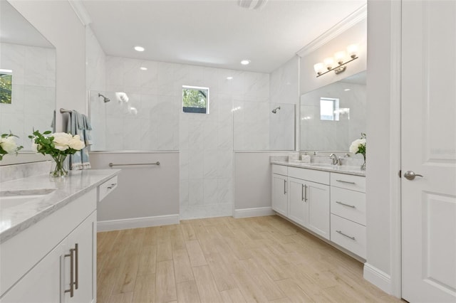 9844 Beach Port Dr, Winter Garden, FL 34787 - bathroom with two vanities, plenty of natural light, walk in shower, wood finished floors, and crown molding