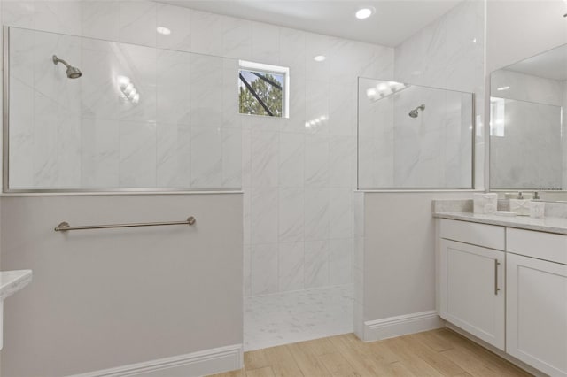 9844 Beach Port Dr, Winter Garden, FL 34787 - bathroom with a walk in shower, wood finished floors, and vanity