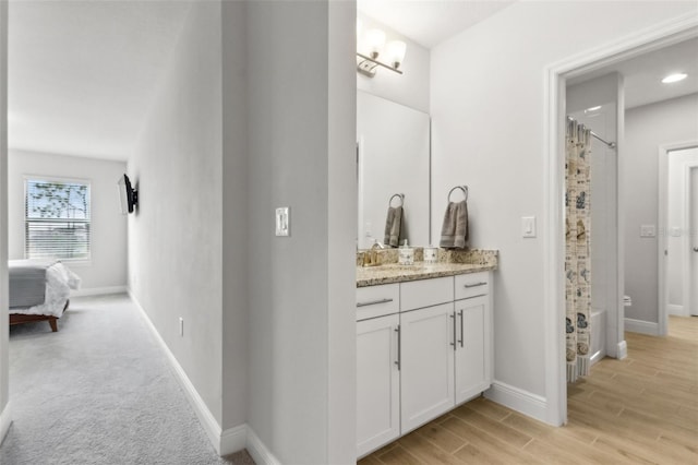 9844 Beach Port Dr, Winter Garden, FL 34787 - bathroom featuring vanity, curtained shower, baseboards, wood finished floors, and toilet