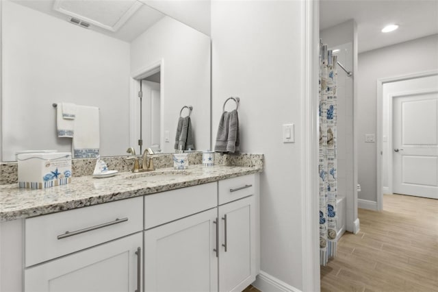 9844 Beach Port Dr, Winter Garden, FL 34787 - full bath with vanity, wood finished floors, baseboards, recessed lighting, and shower / bath combo