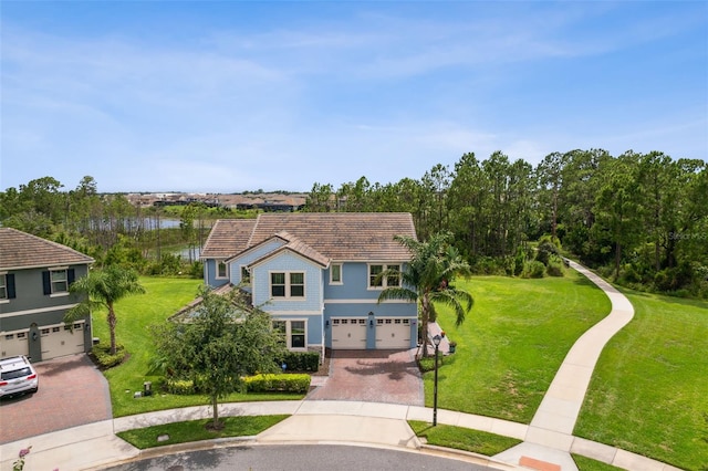 9844 Beach Port Dr, Winter Garden, FL 34787 - traditional-style house with decorative driveway, an attached garage, a front yard, and stucco siding