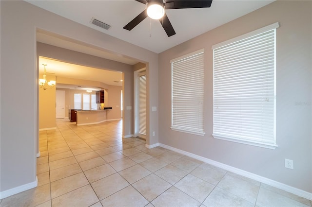 3651 NW 56th Ave, Ocala, FL 34482 - unfurnished room featuring ceiling fan, light tile patterned flooring, baseboards, and a chandelier