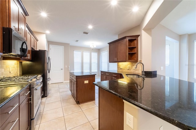 3651 NW 56th Ave, Ocala, FL 34482 - kitchen with stainless steel gas range oven, a sink, open shelves, a center island, and backsplash