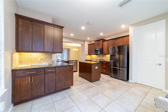 3651 NW 56th Ave, Ocala, FL 34482 - kitchen with appliances with stainless steel finishes, a sink, decorative backsplash, light tile patterned flooring, and a kitchen island