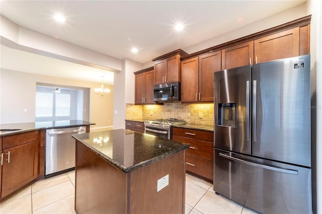 3651 NW 56th Ave, Ocala, FL 34482 - kitchen with appliances with stainless steel finishes, a center island, light tile patterned floors, tasteful backsplash, and dark stone countertops