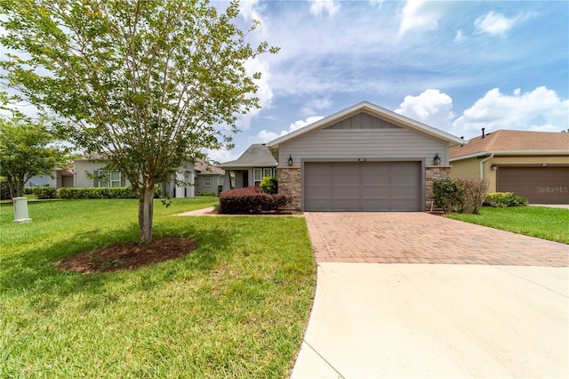3651 NW 56th Ave, Ocala, FL 34482 - ranch-style home with decorative driveway, stone siding, a front lawn, and an attached garage