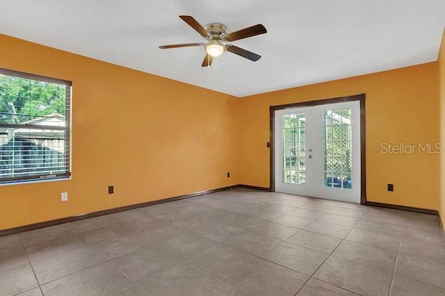 9319 Woodbreeze Blvd, Windermere, FL 34786 - spare room with healthy amount of natural light, french doors, and baseboards