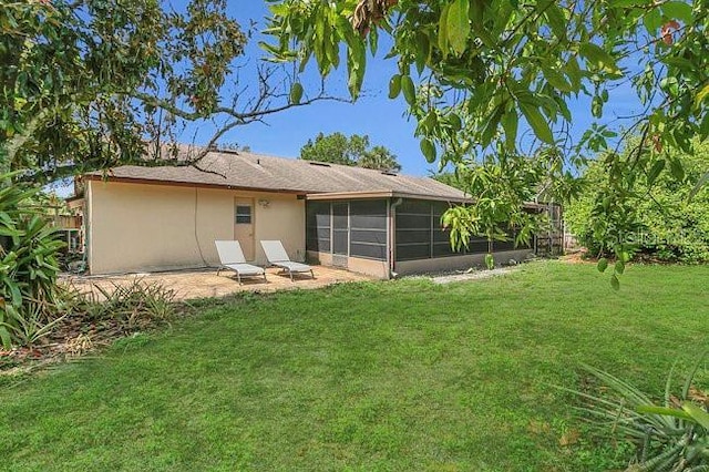 9319 Woodbreeze Blvd, Windermere, FL 34786 - back of house featuring a lawn, a sunroom, and stucco siding