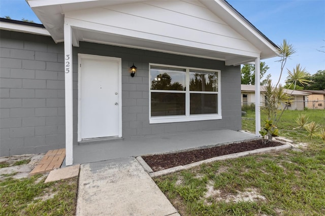 325 Little Aspen Ct, Ocoee, FL 34761 - doorway to property featuring covered porch and concrete block siding