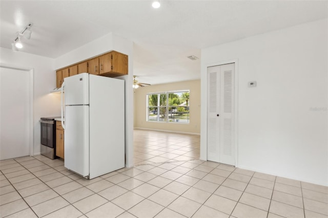 325 Little Aspen Ct, Ocoee, FL 34761 - kitchen with freestanding refrigerator, stainless steel range with electric cooktop, a ceiling fan, and light tile patterned flooring