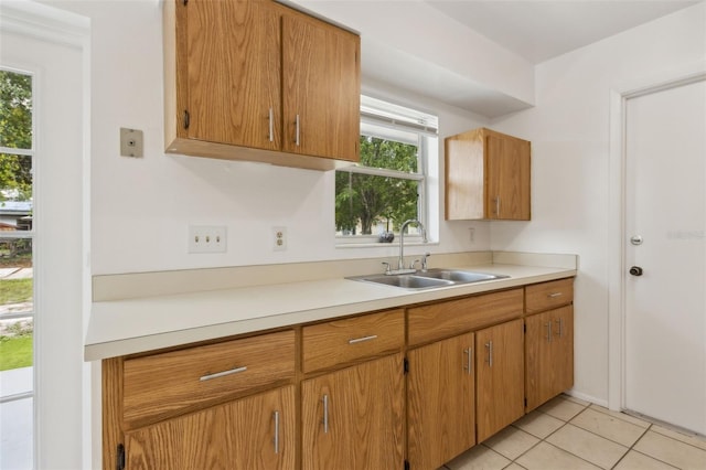 325 Little Aspen Ct, Ocoee, FL 34761 - kitchen featuring light countertops, light tile patterned floors, and brown cabinetry