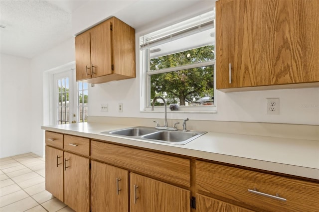 325 Little Aspen Ct, Ocoee, FL 34761 - kitchen featuring light countertops, light tile patterned floors, and brown cabinets