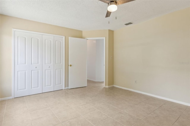 325 Little Aspen Ct, Ocoee, FL 34761 - unfurnished bedroom with a textured ceiling, a closet, light tile patterned floors, and ceiling fan