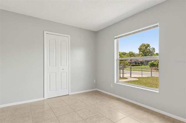 325 Little Aspen Ct, Ocoee, FL 34761 - empty room with baseboards and light tile patterned flooring
