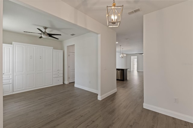 15229 Evergreen Oak Loop, Winter Garden, FL 34787 - unfurnished living room featuring a chandelier, a ceiling fan, dark wood-type flooring, and baseboards