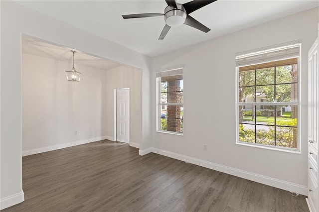 15229 Evergreen Oak Loop, Winter Garden, FL 34787 - empty room featuring healthy amount of natural light, dark wood-type flooring, and baseboards