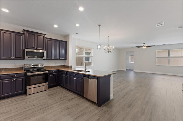 15229 Evergreen Oak Loop, Winter Garden, FL 34787 - kitchen with stainless steel appliances, a sink, light wood-type flooring, plenty of natural light, and recessed lighting