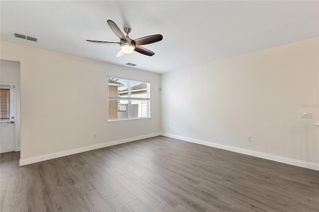 15229 Evergreen Oak Loop, Winter Garden, FL 34787 - spare room with dark wood-style floors, ceiling fan, and baseboards