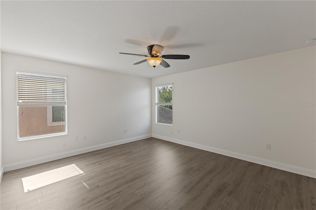 15229 Evergreen Oak Loop, Winter Garden, FL 34787 - spare room with dark wood finished floors, ceiling fan, and baseboards