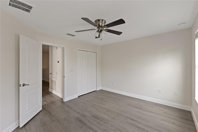 15229 Evergreen Oak Loop, Winter Garden, FL 34787 - unfurnished bedroom featuring wood finished floors, baseboards, a closet, and a ceiling fan