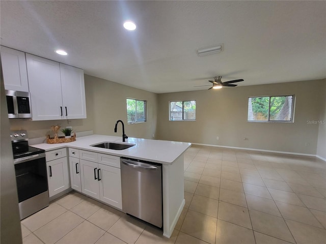 4883 Cherokee Rose Dr, Orlando, FL 32808 - kitchen featuring stainless steel appliances, a sink, light countertops, a peninsula, and open floor plan