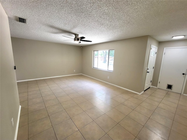 4883 Cherokee Rose Dr, Orlando, FL 32808 - spare room with a ceiling fan, a textured ceiling, baseboards, and light tile patterned flooring