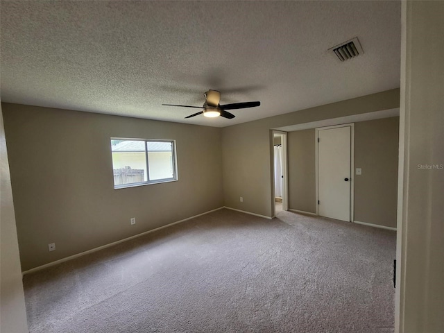 4883 Cherokee Rose Dr, Orlando, FL 32808 - empty room featuring carpet flooring, a ceiling fan, a textured ceiling, and baseboards