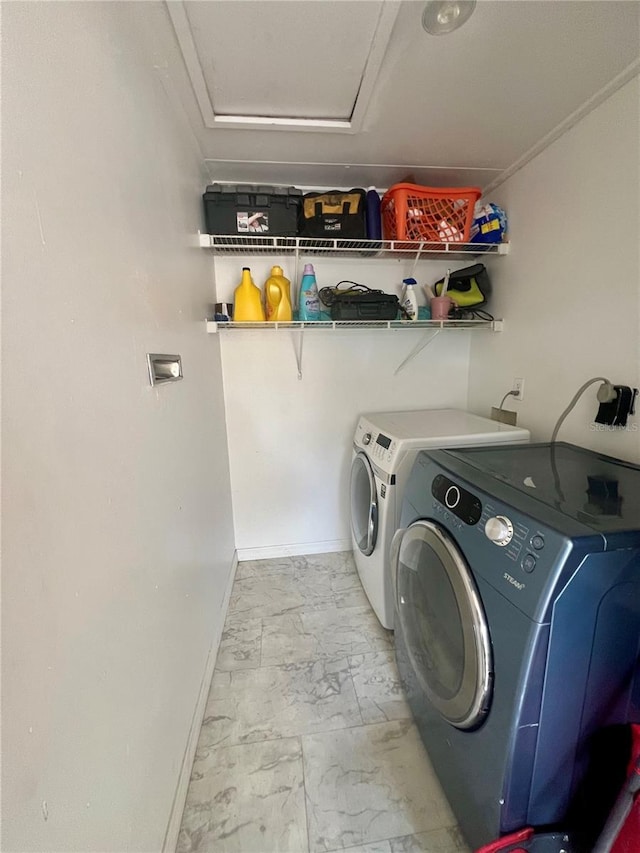 1815 Townhall Ln Unit 1815, Orlando, FL 32807 - washroom with washer and clothes dryer, marble finish flooring, baseboards, and attic access