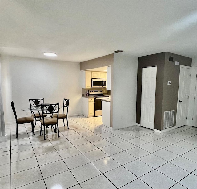 1815 Townhall Ln Unit 1815, Orlando, FL 32807 - dining area with light tile patterned flooring and baseboards