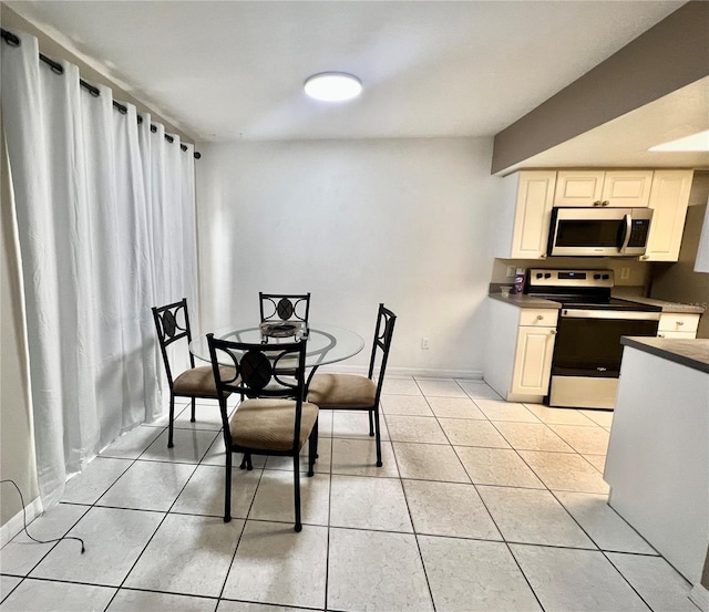 1815 Townhall Ln Unit 1815, Orlando, FL 32807 - dining room featuring light tile patterned floors