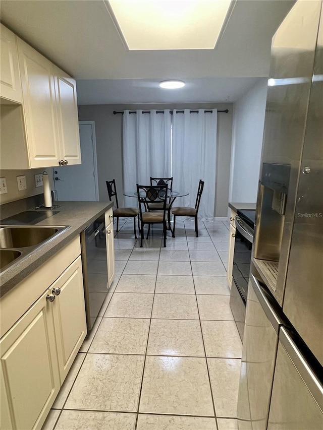 1815 Townhall Ln Unit 1815, Orlando, FL 32807 - kitchen featuring stainless steel appliances, dark countertops, light tile patterned floors, and a sink