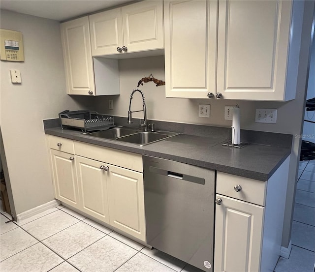 1815 Townhall Ln Unit 1815, Orlando, FL 32807 - kitchen with stainless steel dishwasher, a sink, dark countertops, and light tile patterned floors