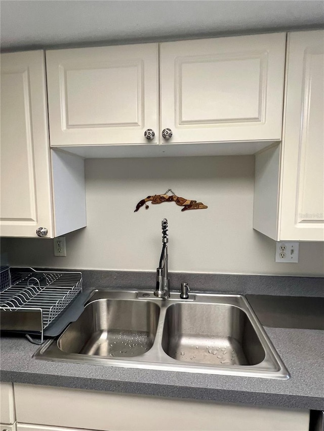 1815 Townhall Ln Unit 1815, Orlando, FL 32807 - kitchen view of a sink, white cabinets, and dark countertops