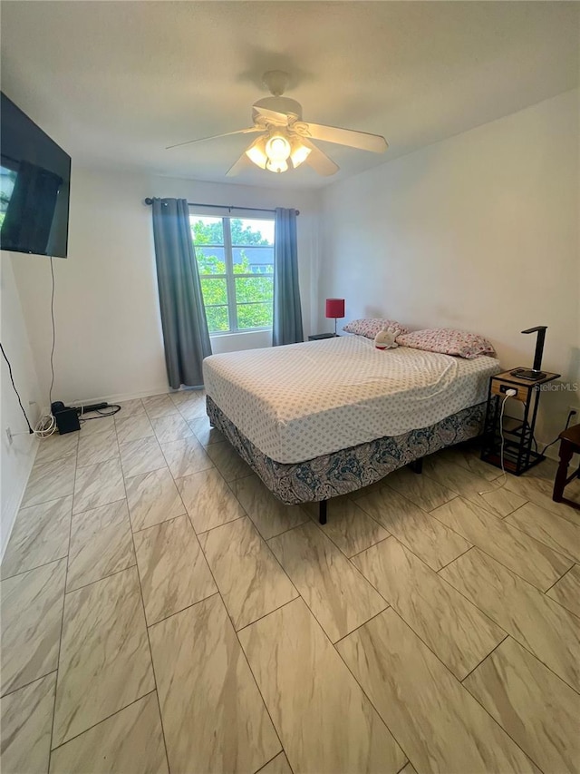 1815 Townhall Ln Unit 1815, Orlando, FL 32807 - bedroom with light marble finish floors, a ceiling fan, and baseboards