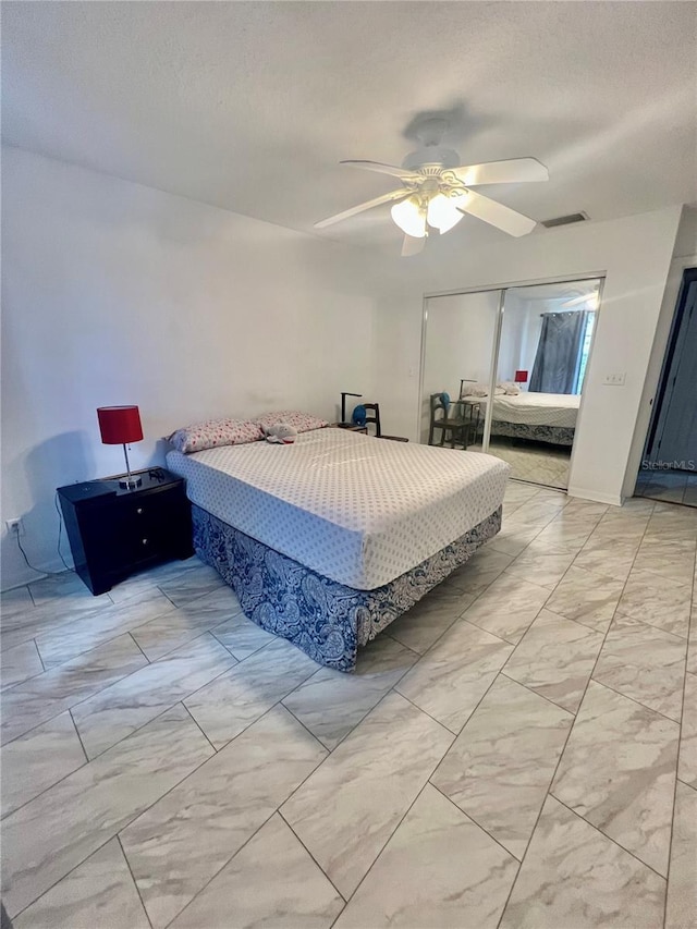1815 Townhall Ln Unit 1815, Orlando, FL 32807 - bedroom featuring a closet, a textured ceiling, light marble finish flooring, and ceiling fan