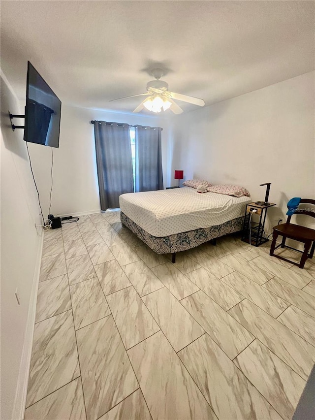 1815 Townhall Ln Unit 1815, Orlando, FL 32807 - bedroom featuring light marble finish floors, a ceiling fan, and baseboards