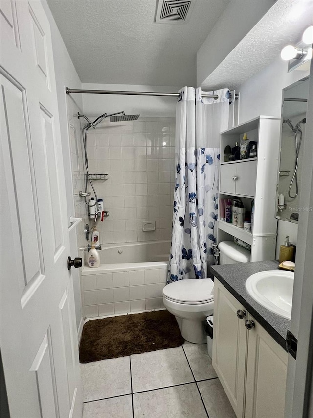 1815 Townhall Ln Unit 1815, Orlando, FL 32807 - full bathroom with tile patterned flooring, vanity, shower / bath combination with curtain, toilet, and a textured ceiling