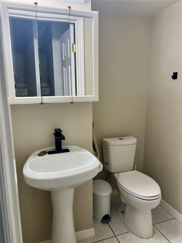 1815 Townhall Ln Unit 1815, Orlando, FL 32807 - bathroom with tile patterned floors, toilet, baseboards, and a sink