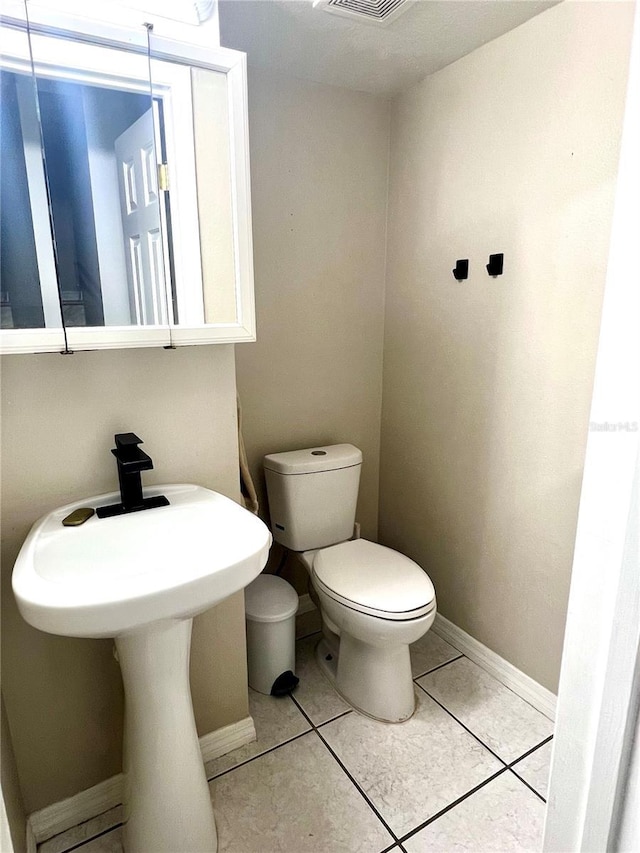 1815 Townhall Ln Unit 1815, Orlando, FL 32807 - half bath featuring toilet, baseboards, and tile patterned floors