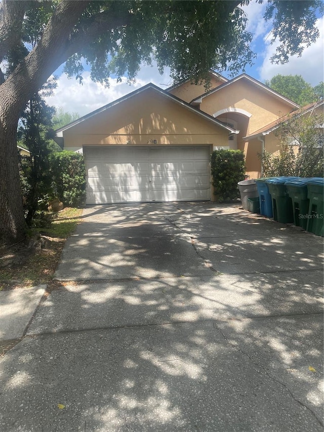 2155 Fennell St, Maitland, FL 32751 - view of front of property featuring concrete driveway, a garage, and stucco siding