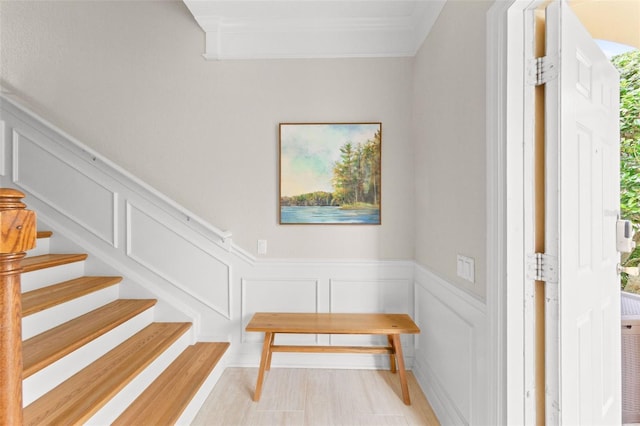 8024 Cool Breeze Dr Unit 132, Orlando, FL 32819 - stairs featuring a decorative wall, ornamental molding, and wainscoting