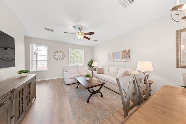 8024 Cool Breeze Dr Unit 132, Orlando, FL 32819 - living room featuring light wood finished floors, ceiling fan, and baseboards