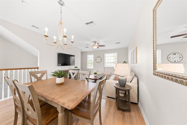 8024 Cool Breeze Dr Unit 132, Orlando, FL 32819 - dining room featuring ceiling fan, light wood-style flooring, a chandelier, and baseboards