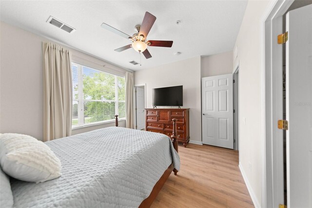 8024 Cool Breeze Dr Unit 132, Orlando, FL 32819 - bedroom with light wood finished floors, baseboards, and a ceiling fan