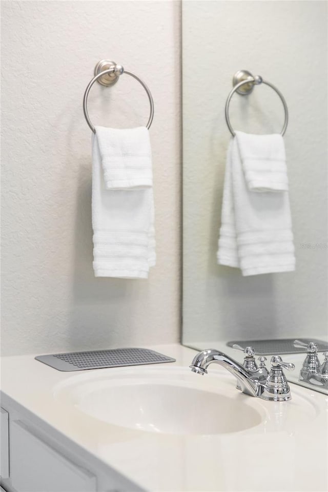 8024 Cool Breeze Dr Unit 132, Orlando, FL 32819 - bathroom with vanity and a textured wall