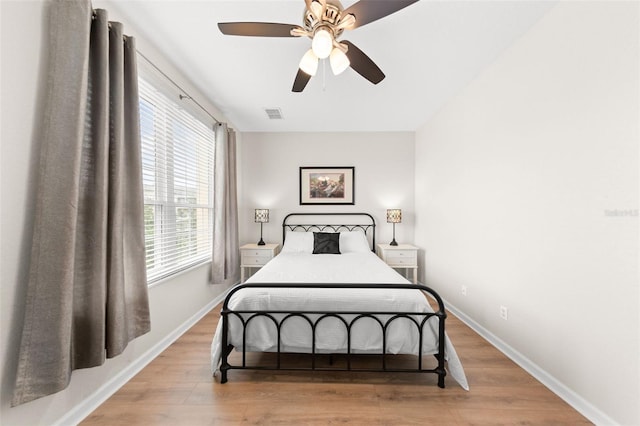 8024 Cool Breeze Dr Unit 132, Orlando, FL 32819 - bedroom with light wood-type flooring, baseboards, and a ceiling fan