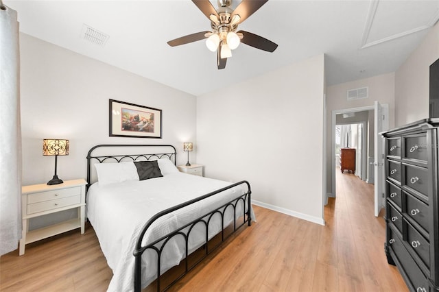 8024 Cool Breeze Dr Unit 132, Orlando, FL 32819 - bedroom with light wood-style floors, attic access, baseboards, and a ceiling fan